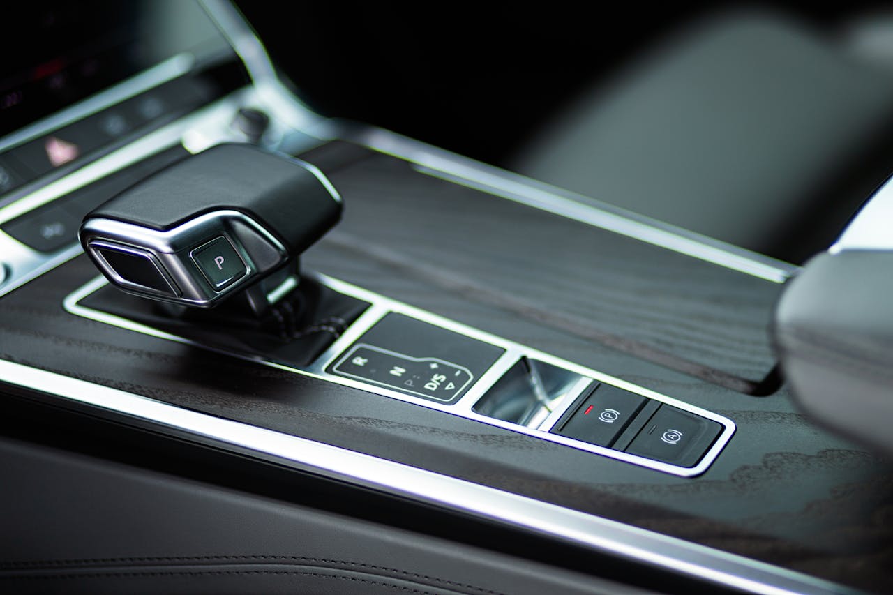 Close-up view of a sleek automatic gearbox in a luxurious car interior.