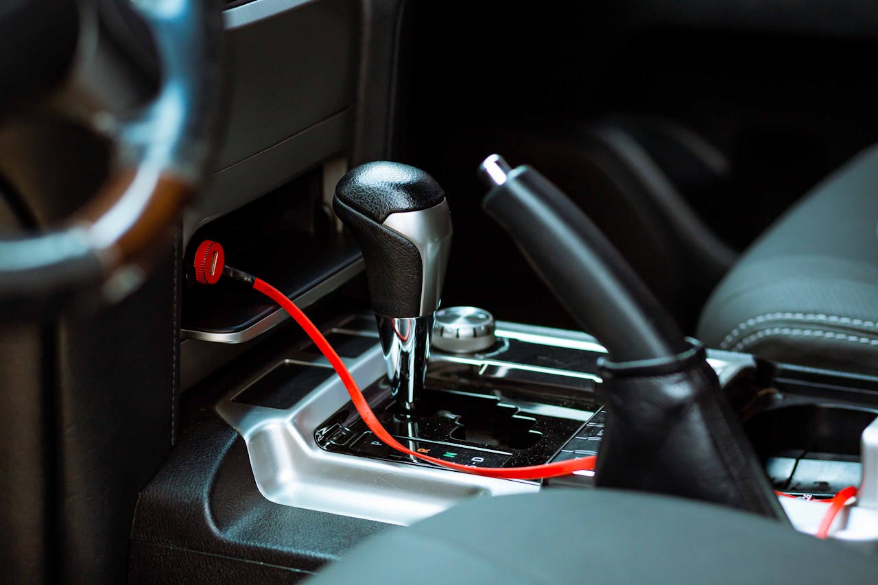 Close-up of a car's gearshift and handbrake highlighting the modern vehicle interior.