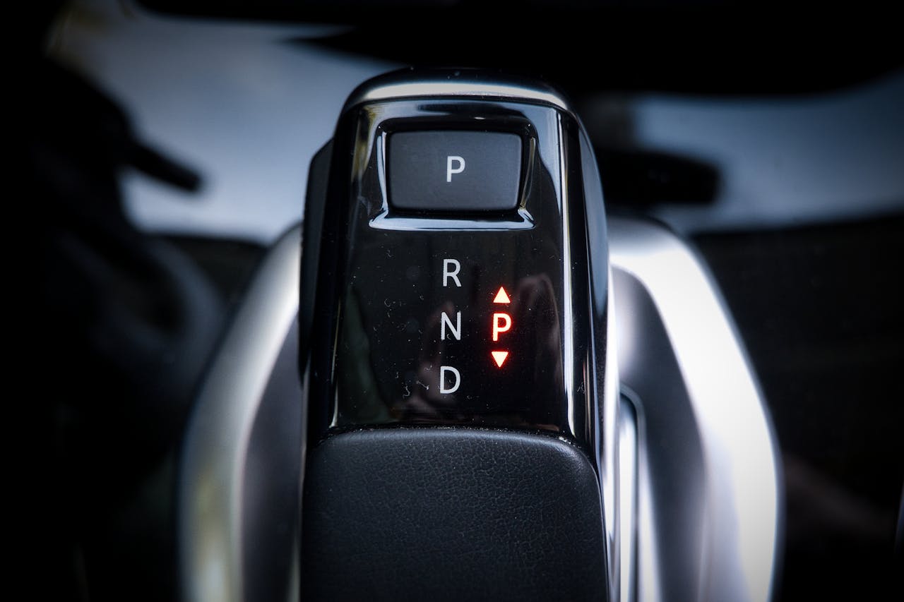 Detailed view of a modern automatic car gear shifter displaying P, R, N, D settings.